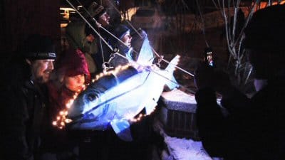 KISS THE FISH! Bill and Stacey Ross of Albany, N.Y., came to Eastport for the Great Sardine and Maple Leaf Drop on New Year's Eve and took part in the tradition of kissing the sardine for go