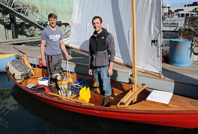 FINISHING THEIR JOURNEY from Portland to Eastport in a 17-foot Swampscott dory on October 8 are Paul Moughamian (left), Jayme Schroeder and Echo, a husky who stayed still during the trip. Th