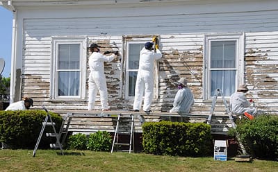 GETTING READY FOR A NEW COAT OF PAINT this summer is this Eastport house, which is being scraped by volunteers from the Assist-JC group of All Souls Congregational Church in Bangor. (Edward 