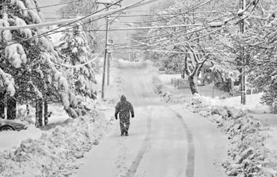 HEADING UP MARCH HILL, as winter continues into spring, this walker in Eastport’s South End looks over the snowfall after the March 13–14 storm. (Edward French photo)