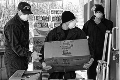 HELPING OUT during the COVID-19 pandemic are coastguardmen from U.S. Coast Guard Station Eastport, who carry in bags of food from the Good Shepherd Food Bank at the Garrapy Food Pantry in Ea