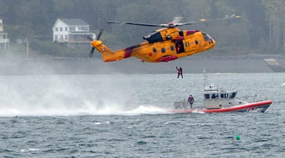 A CORMORANT HELICOPTER out of Greenwood, N.S., lifts a coastguardsman from U.S. Coast Guard Station Eastport’s 45-foot response boat during a training exercise off Eastport on October 4. See