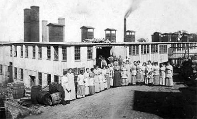 WORKERS STAND in front of the Columbian Packing factory in Lubec in this circa 1912 photograph. See this issue of The Quoddy Tides for an article about the history of the Columbian plant and