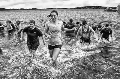 PARTICIPANTS return to shore after running into the cold waters of the bay during the Polar Bear Dip, held on February 28 at Split Rock, Sipayik. Over $17,000 was raised for Sarah’s House of