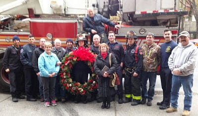 SHOWN with their donated remembrance wreath are members of the Mingo family of Red Beach with firefighters of the New York City Fire Department Station E16/TL7 of lower Manhattan. After 9/11