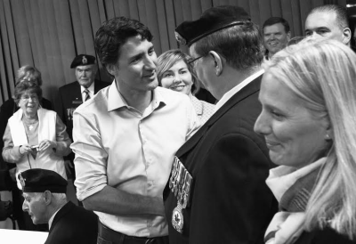 SHAKING HANDS with area veterans as local MP Karen Ludwig (center) and Minister of Environment Catherine McKenna (right) look on is Canadian Prime Minister Justin Trudeau during his working 