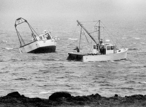 AGROUND near Split Rock, Pleasant Point, is Scott MacNichol's vessel, Miss Amy, on April 24. Angus McPhail's boat, Julie Ann, assisted in keeping the vessel upright as it began to float off 