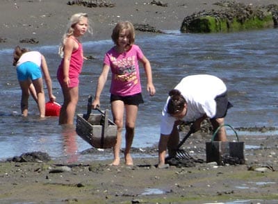 SUMMER MEMORIES ARE MADE as a family tries their hand at digging clams at Carrying Place Cove in Lubec. (Chessie Crowe Gartmayer photo)