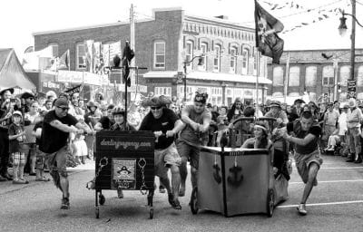 WATCH OUT! HERE WE COME! Racing against time and each other are Eastport Pirate Festival bed race participants. The races were won by the "Friendly Pirates" of The New Friendly Restaurant. S