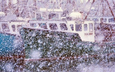 A WINTER'S DAY IN DOWNEAST MAINE. The scallop dragger Bay Boys is tied up after a day of fishing, as snow falls heavily at the Eastport breakwater. (Edward French photo) Subscribe to Quoddy 