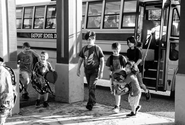HEADING BACK TO SCHOOL after summer vacation are these Eastport Elementary School students coming off the bus for the first day of school. (Edward French photo)