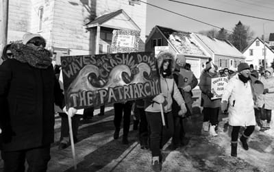JOAN LOWDEN calls a chant through her handmade megaphone as she leads the crowd to downtown Eastport during the fourth annual Women’s March on Saturday, January 18. The march also marked the