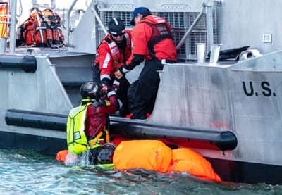 PICKING UP survivors from a life raft are crew members on the U.S. Coast Guard Station Eastport’s 47-foot motor lifeboat, during the joint search and rescue exercise held with the Canadian C