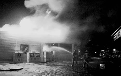 FIGHTING THE FIRE at the Irving Mainway convenience store in Eastport early in the morning on Wednesday, February 6, are Eastport and Perry firefighters. The blaze destroyed the store. (Tom 