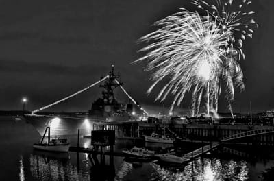 FIREWORKS light the sky over the destroyer U.S.S. Jason Dunham during Eastport’s Fourth of July celebration.