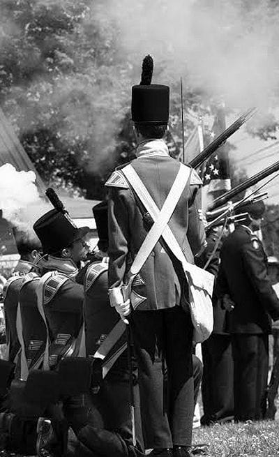 THE BRITISH ARE HERE! Soldiers from the Halifax Citadel, wearing the uniforms of the 104th Regiment of Foot, fire their muskets as part of the commemoration of the 200th anniversary of the c
