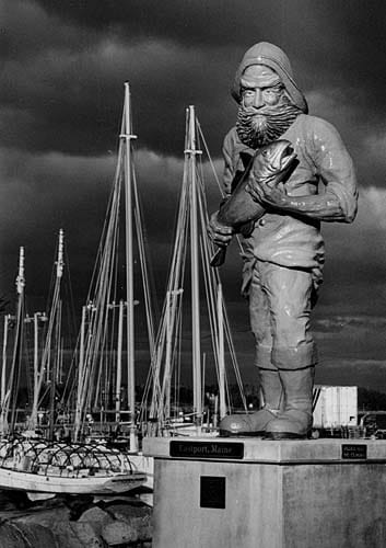 GOING DOWN TO THE SEA IN SHIPS is possible in Eastport, where the city's heritage is reflected in the mass of masts behind the fisherman statue that stands on the shore. (Edward French photo