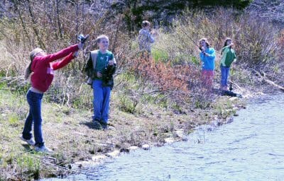 GONE FISHING. Trying their hand at casting at the Mill Pond in Whiting on a warm spring day are second and third graders in Stephen Richard's physical education class at the Whiting Village 