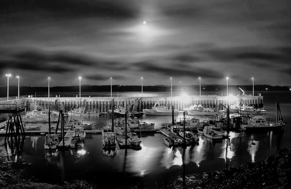 THE FULL HARVEST MOON, along with Mars to the left, breaks through the clouds over the Eastport breakwater on October 1. (Don Dunbar photo)