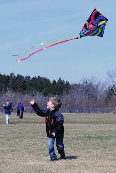 FLYING HIGH. Kindergartner Fox Brigham was among the Eastport Elementary School students who took part in a spring kite-flying day on the Battery Field behind the school on April 18. (Edward