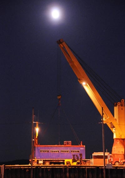 AROUND THE WORLD. Under a full moon, the Clipper Mariner loads cows and horses for Russia and wood pulp for Turkey at the Eastport breakwater. (Edward French photo)