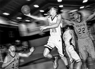 FLYING PAST THE DEFENSE, Shead Tiger Matt Harris scores a basket against Machias on February 4. Although Machias won, the Tigers had another chance, as they faced the Bulldogs again in the B