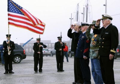 SALUTING during the Memorial Day ceremony at the Eastport breakwater, after casting wreaths into the waters in memory of servicemen lost at sea, are U.S. Navy veteran James Spinney, Gary Cra