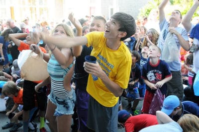 PENNIES FROM HEAVEN. Excited youths reach for pennies and more during the Penny Scramble on the Fourth of July in Eastport. (Edward French photo) Subscribe to Quoddy TidesRates:$31.65 a year