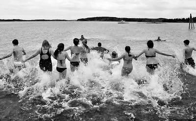 HEADING into the water during the Washington County Community College Polar Bear Dip on March 15 at Pleasant Point are students from Calais High School. About 100 dippers from as far away as