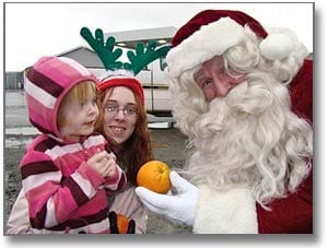 BIG AND LITTLE CLAUS. Jason Cook Jr., dressed as Santa, visits with the larger version on Sunday afternoon, December 9, at the Eastport Youth Center. The Eastport Youth Association sponsored