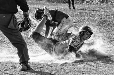 SAFE! Jacob Cook of the Shead Tigers slides safely into home plate during a high school baseball game against the Narraguagus Knights on May 9. Narraguagus ended up winning the game by a sco