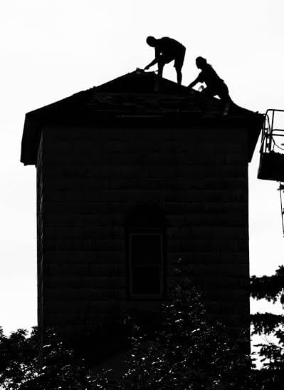 CLIMBING TO THE TOP. Working on the steeple of the former North Baptist/Christian Church building in Eastport are John Nicholas and Sam Gilbert of Ryan Newell Construction. The building was 