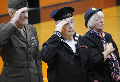 REMEMBERING as they salute during the playing of Taps at the Veterans Day service in Eastport are U.S. Marine Corps veteran J. Roland Mitchell, U.S. Navy veteran Jim Spinney and Patti Craig 