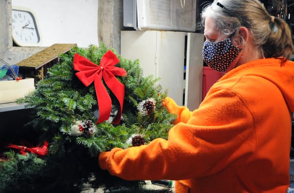 'TIS THE SEASON. Ringing in the holidays is Kathy Moholland of Robbinston, who makes about 150 Christmas wreaths each season, selling them at a roadside stand. She's made wreaths for close t