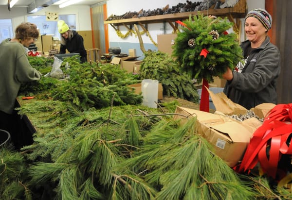 'TIS THE SEASON. Making wreaths and kissing balls at Mingo's Evergreen Products in Robbinston are (from left) Beatrix Stewart, Amy Kolenut and Kourtney Shirley. See this issue for an article