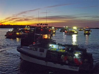 HEADING OUT at the break of dawn on the first day of the lobster season on November 10 is a fleet of boats at Ingalls Head, Grand Manan. All involved were thankful for the excellent weather.