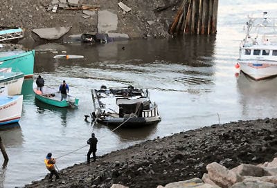 PULLING TOGETHER to help the fishermen whose boats were damaged or destroyed after the Eastport breakwater collapsed the night of December 4 were many people, including diver Scott MacNichol