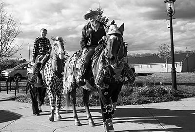 TROTTING OUT their best harvest fashions for the Scarecrow Fest in Calais on October 26 are these congenial horses, ridden by Kelly McIver and Rhonda McIver of Woodland. See this issue for m