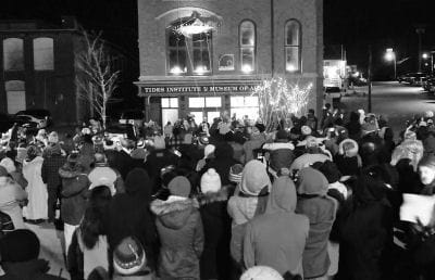 WATCHING as the sardine is lowered at midnight on New Year's Eve is a crowd gathered in Bank Square, Eastport. (Don Dunbar photo)