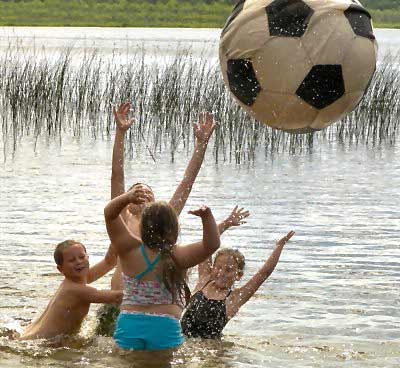 THE SOUNDS OF SUMMER -- giggles and splashes -- can be heard as Adam Olson, 7, Trinity Miliano, 8, Timmy Olson, 11, and Amanda Olson, 6, enjoy a refreshingly cool swim at Round Pond in Charl