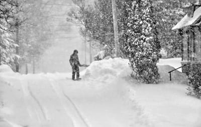 ROARING IN LIKE A LION, the March 4 snowstorm dumped nearly 15" on Eastport. Tom Sexton tries to keep up with the falling snow as he shovels his driveway on Shackford Street – and perhaps ho