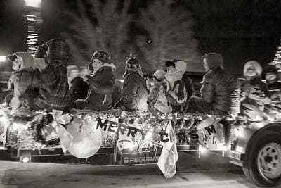 HERE COMES SANTA! Parading through Calais during the Calais Lioness' Christmas parade on Friday night, December 5, were many floats, including this one with local Cub Scouts. (Robin Farrin p