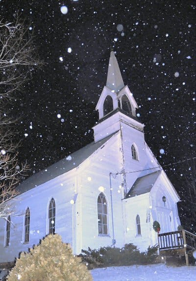 SNOW FALLING FAST in the hushed and holy darkness surrounding the Perry Congregational Meetinghouse during Christmastide. (Edward French photo)