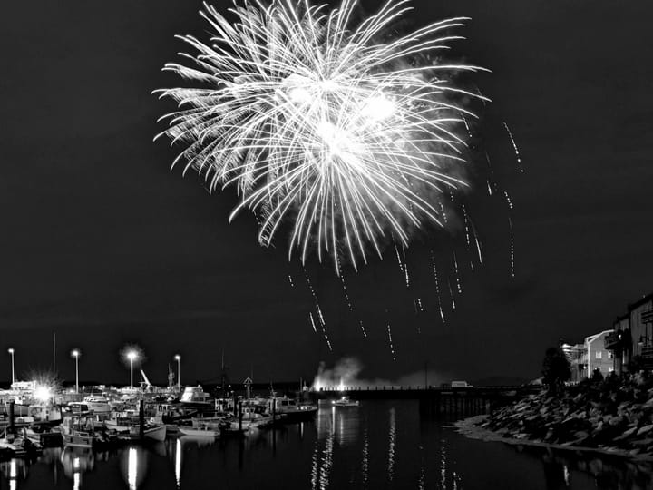 SOAKING UP THE FOURTH. The skies cleared for a fantastic fireworks display over the harbor for the Eastport Fourth of July. Earlier in the day, though, those watching the Grand Parade, like 