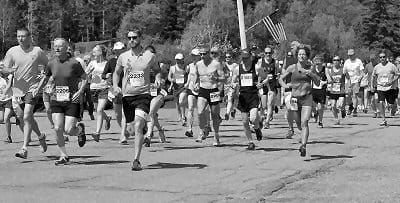 RUNNERS TAKE OFF at the starting line of the 2013 Down East Hospice Volunteers of Washington County fund-raising race on June 1 in Pembroke. (Don Dunbar photo)