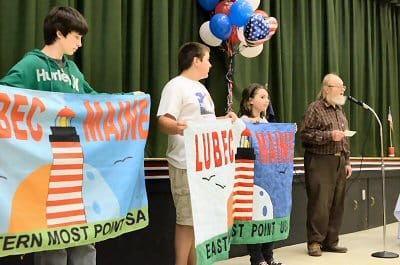 HAPPY 200TH BIRTHDAY, LUBEC! Unfurling the Lubec bicentennial flag on June 21 were (left to right) Seth Doherty, Robert Wallace, Emma Page and Ron Pesha. See the schedule of events in this i