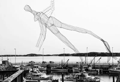 A WINGED MERMAID recently flew over the waters off Eastport and the boats at the breakwater. (Edward French photo)